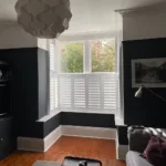 tier on tier shutters in room with black walls